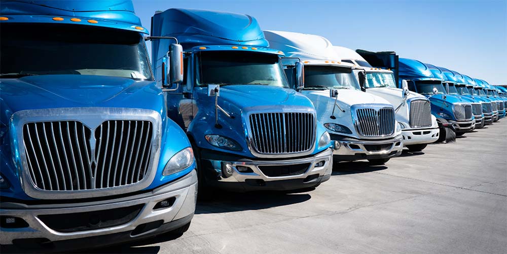 Freight Factoring - image of blue semi trucks - DAL